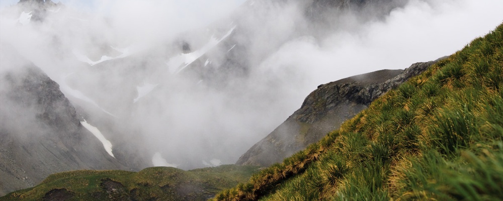 Clouds hanging on the peak. Mountain landscape at Cooper Bay, South Georgia Island.